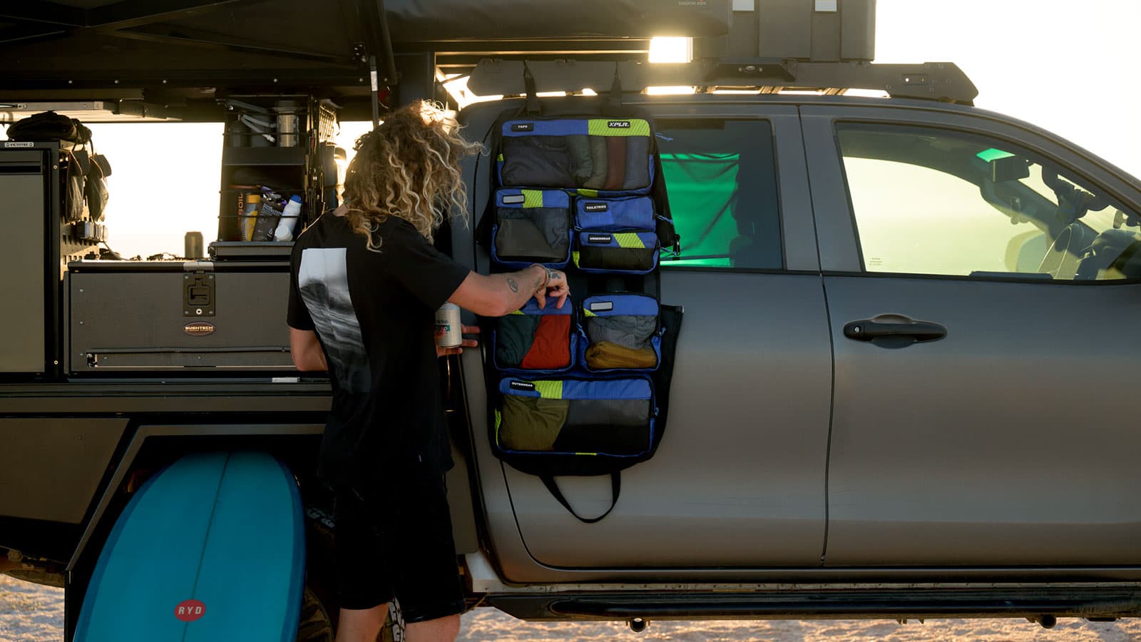 XPLR modular bag hanging from a car door, fully organized